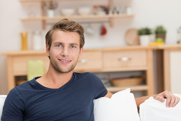 Man Smiling on a Couch